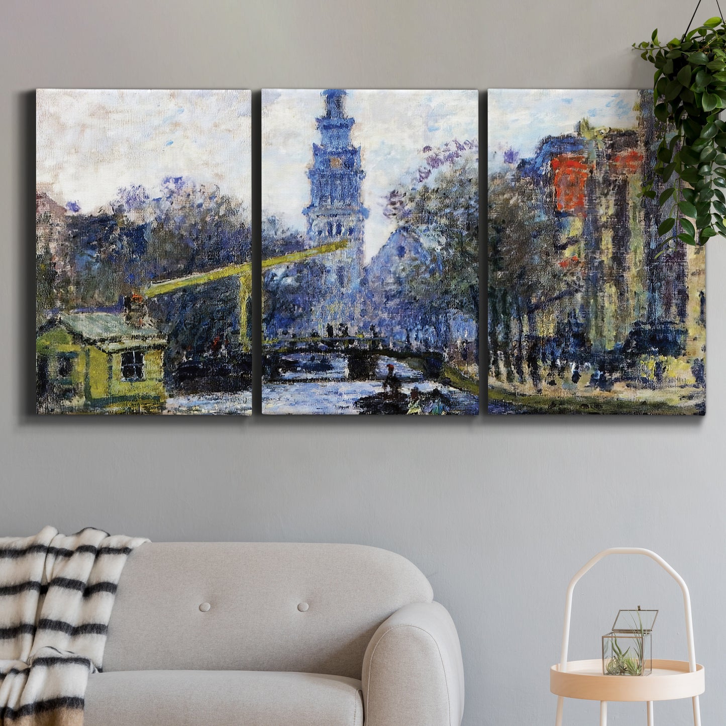 Three-panel canvas wall art featuring historic tower beside canal, displayed in a modern living room above a sofa.