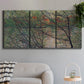 Three-panel canvas wall art featuring spring countryside with fresh foliage, displayed in a modern living room above a sofa.