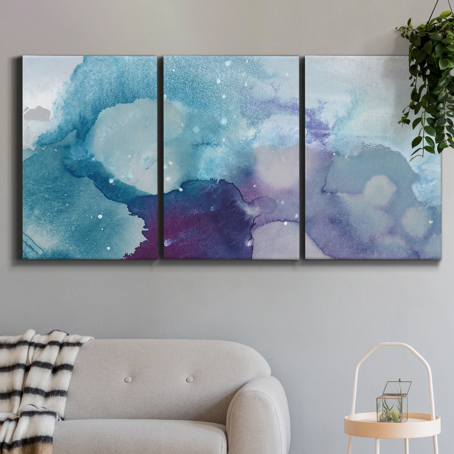 Three-panel canvas wall art featuring icy abstract crystalline forms, displayed in a modern living room above a sofa.