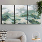 Three-panel canvas wall art featuring lush green hillside rolling landscape, displayed in a modern living room above a sofa.