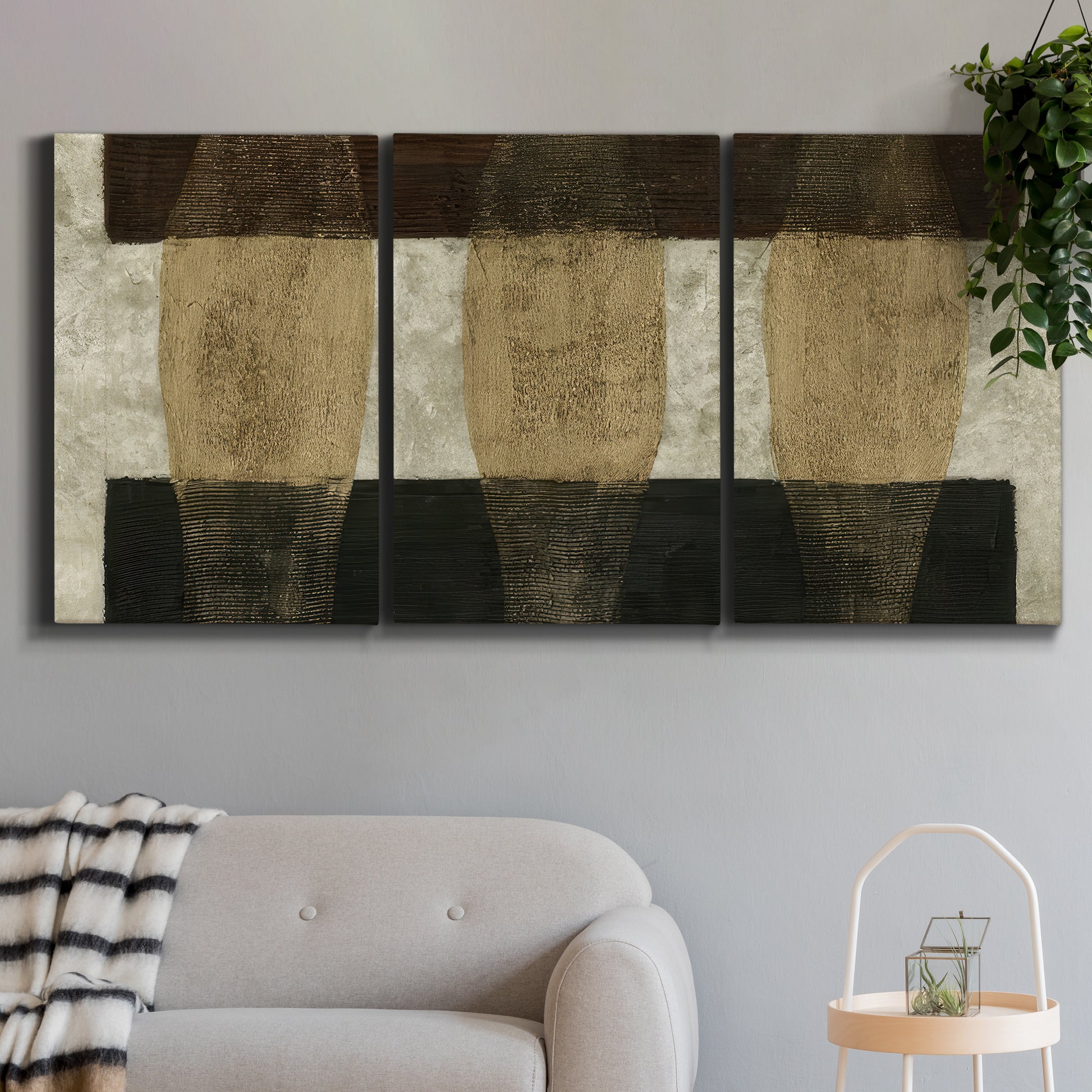 Three-panel canvas wall art featuring textured abstract vessel forms, displayed in a modern living room above a sofa.
