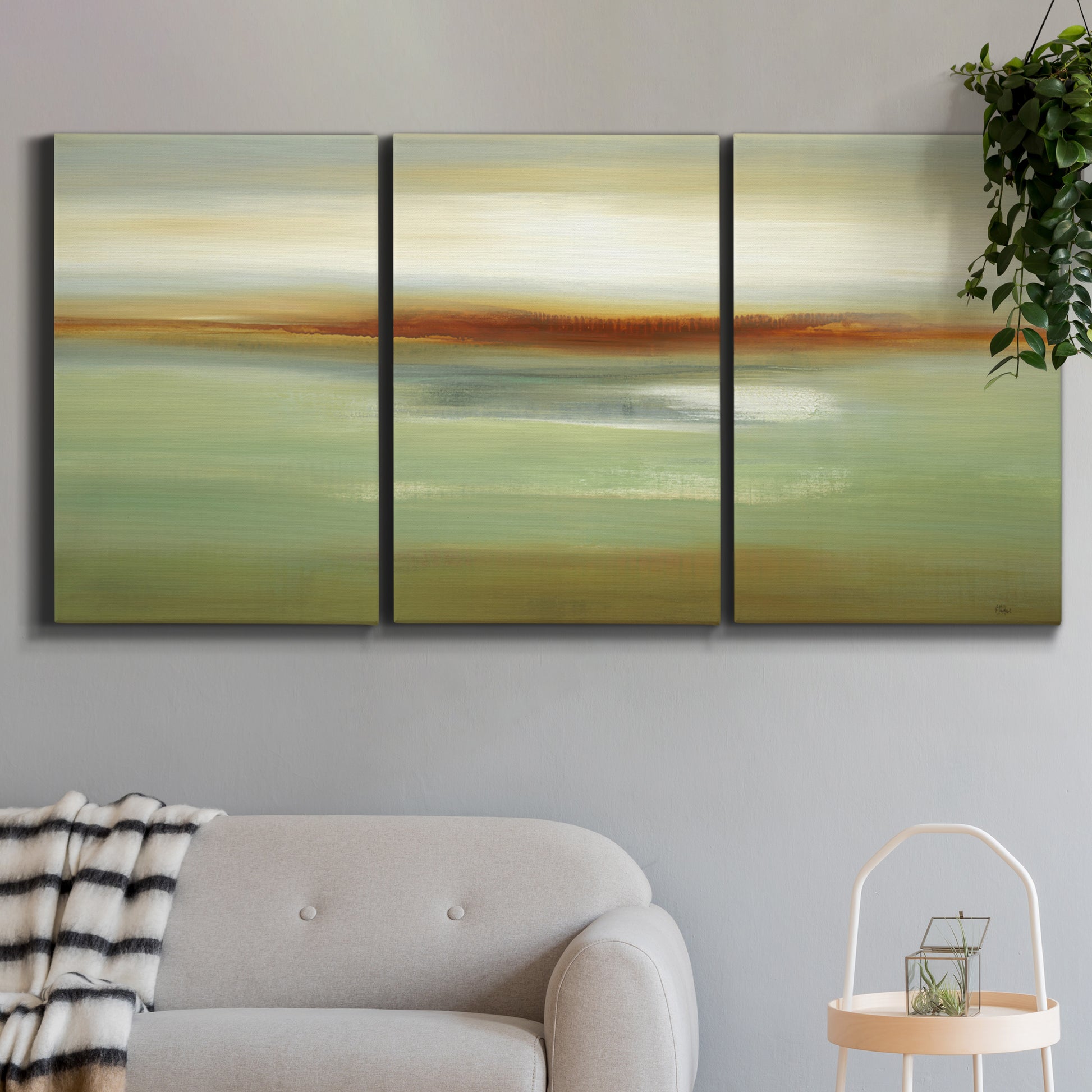 Three-panel canvas wall art featuring green focused abstract color vision, displayed in a modern living room above a sofa.