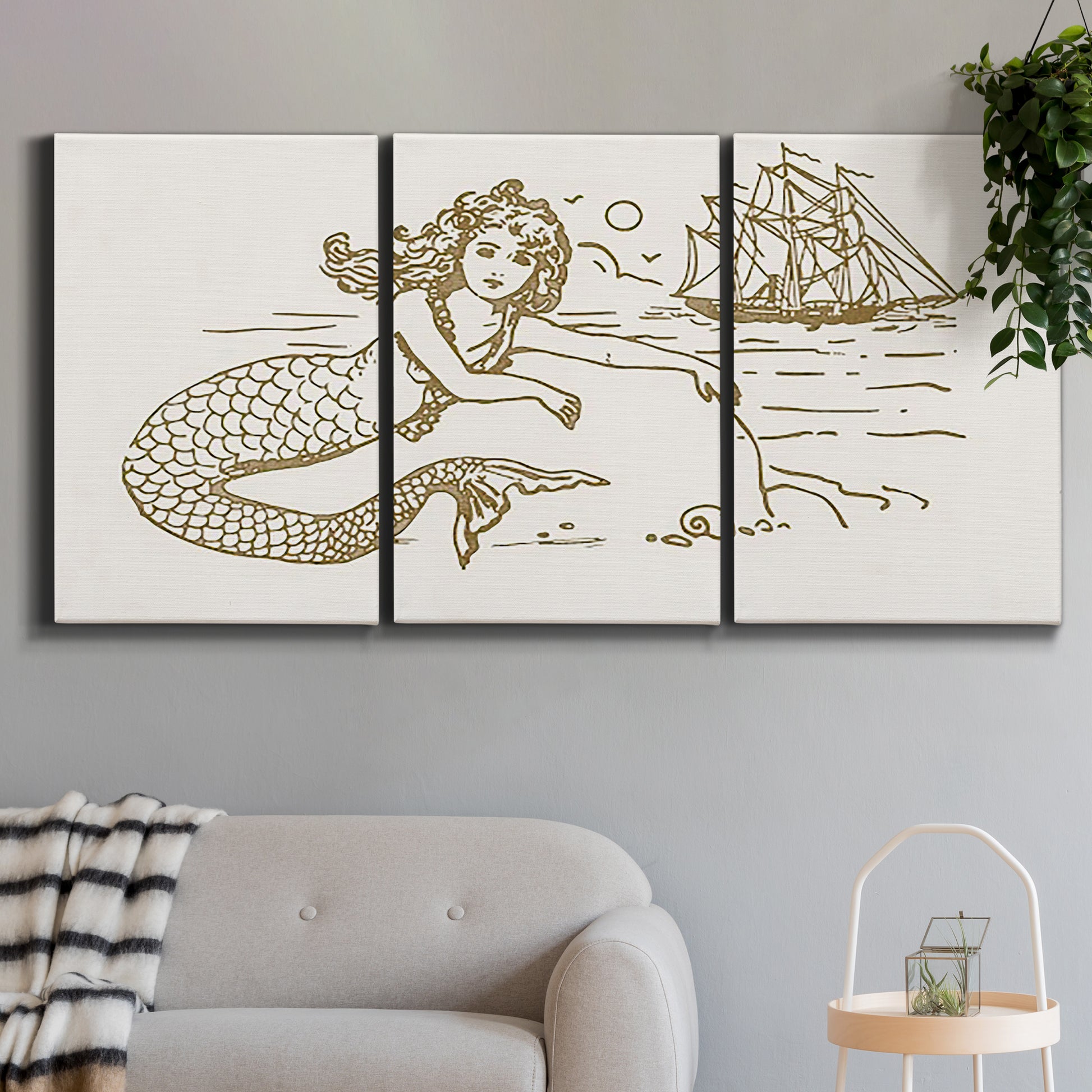 Three-panel canvas wall art featuring whimsical mermaid resting by sea, displayed in a modern living room above a sofa.