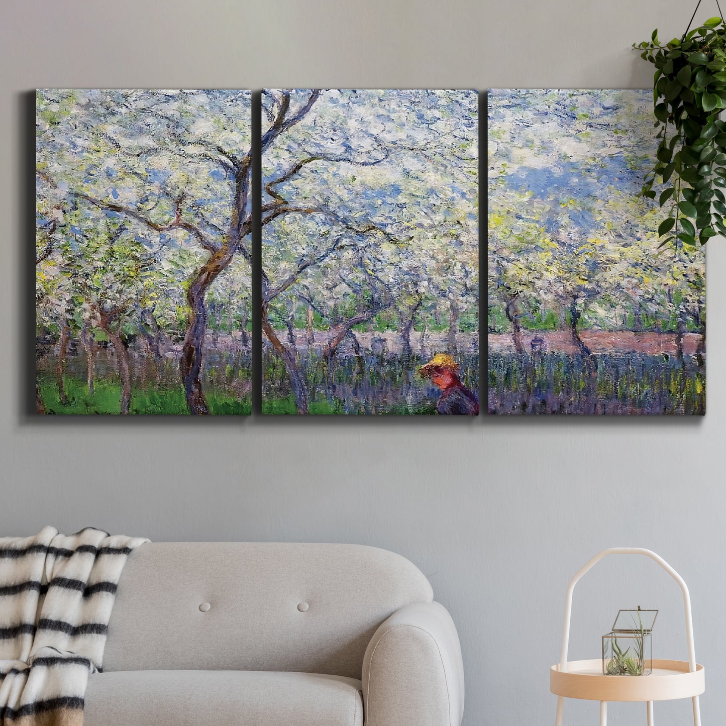 Three-panel canvas wall art featuring fresh spring countryside landscape, displayed in a modern living room above a sofa.