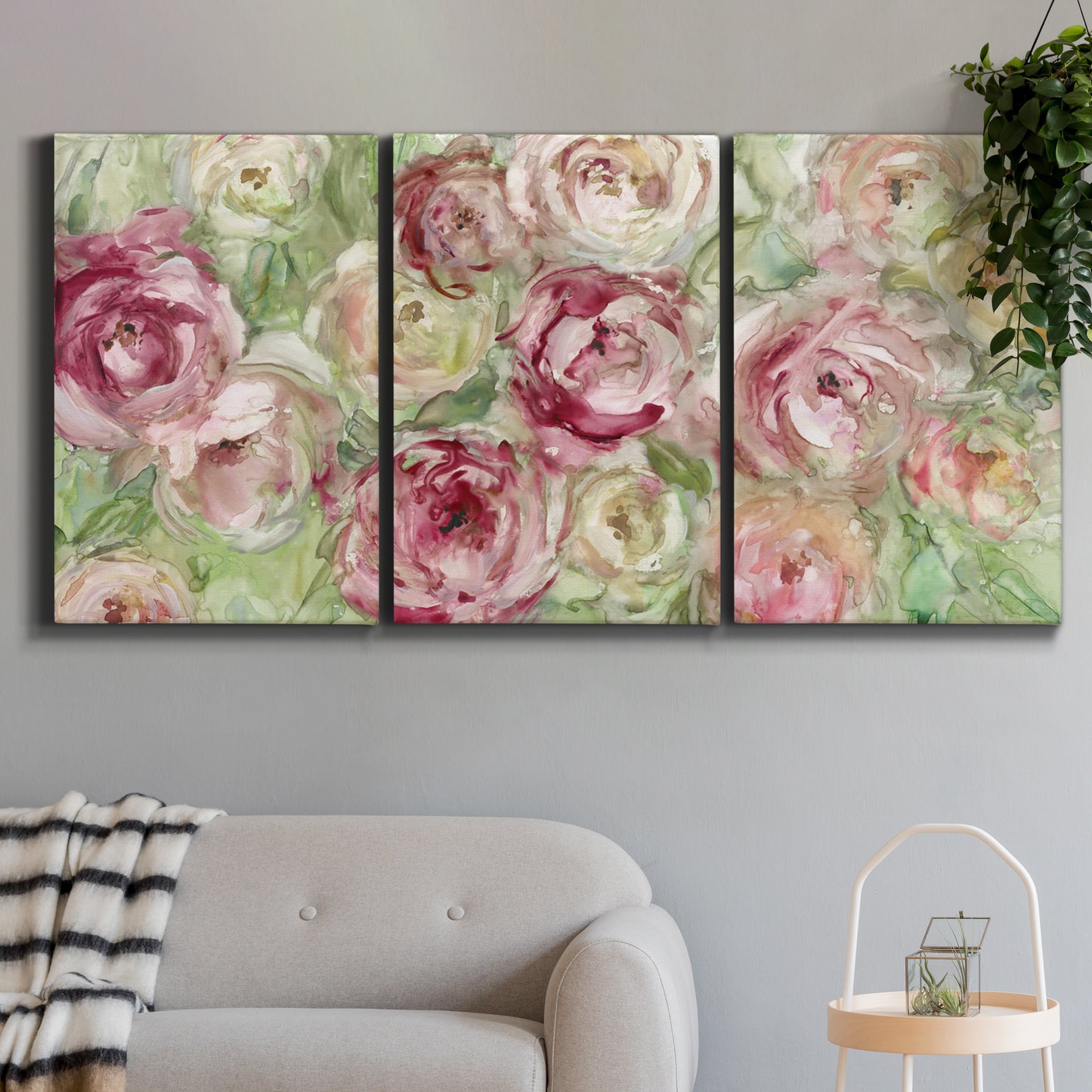 Three-panel canvas wall art featuring blooming climbing rose, displayed in a modern living room above a sofa.