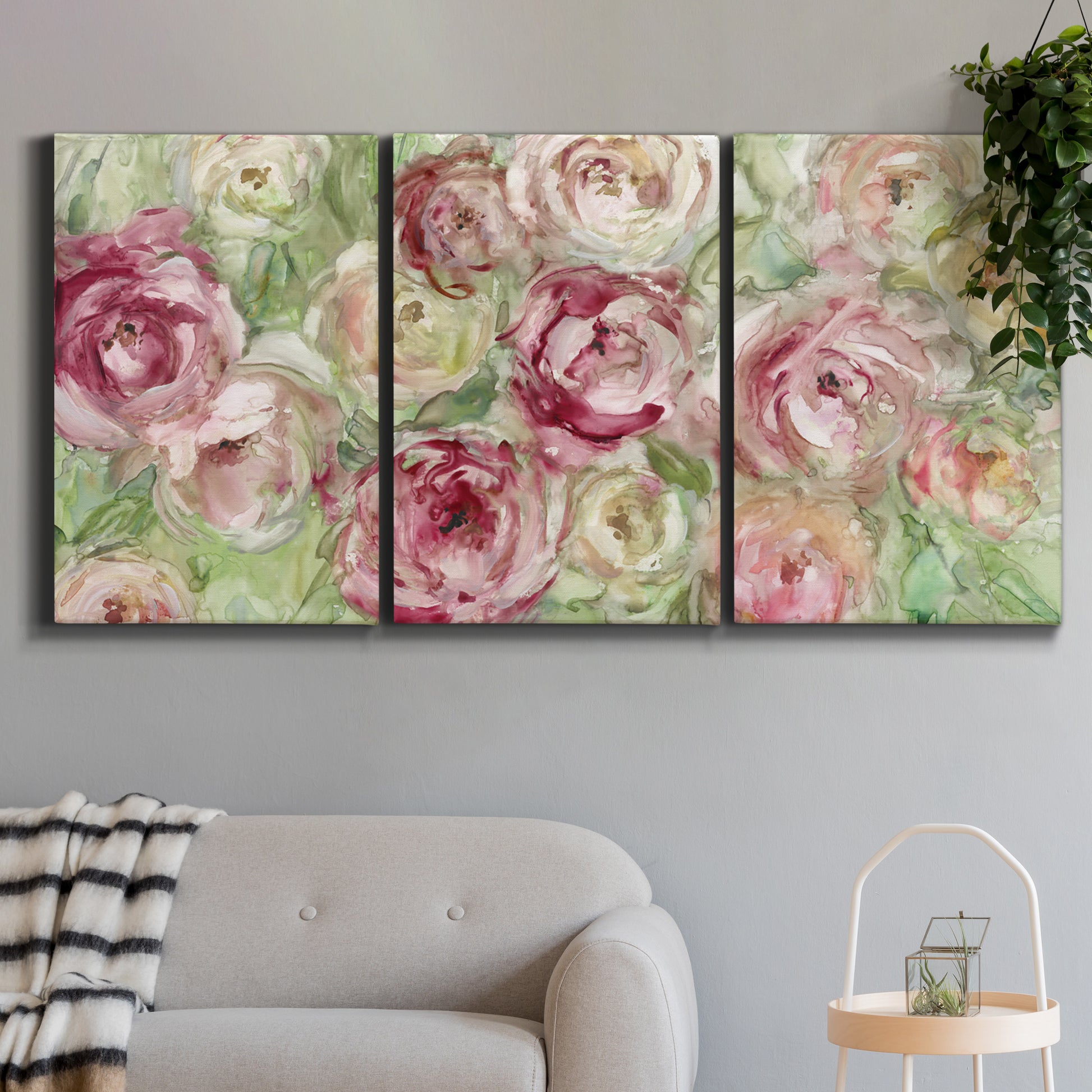 Three-panel canvas wall art featuring blooming climbing rose, displayed in a modern living room above a sofa.