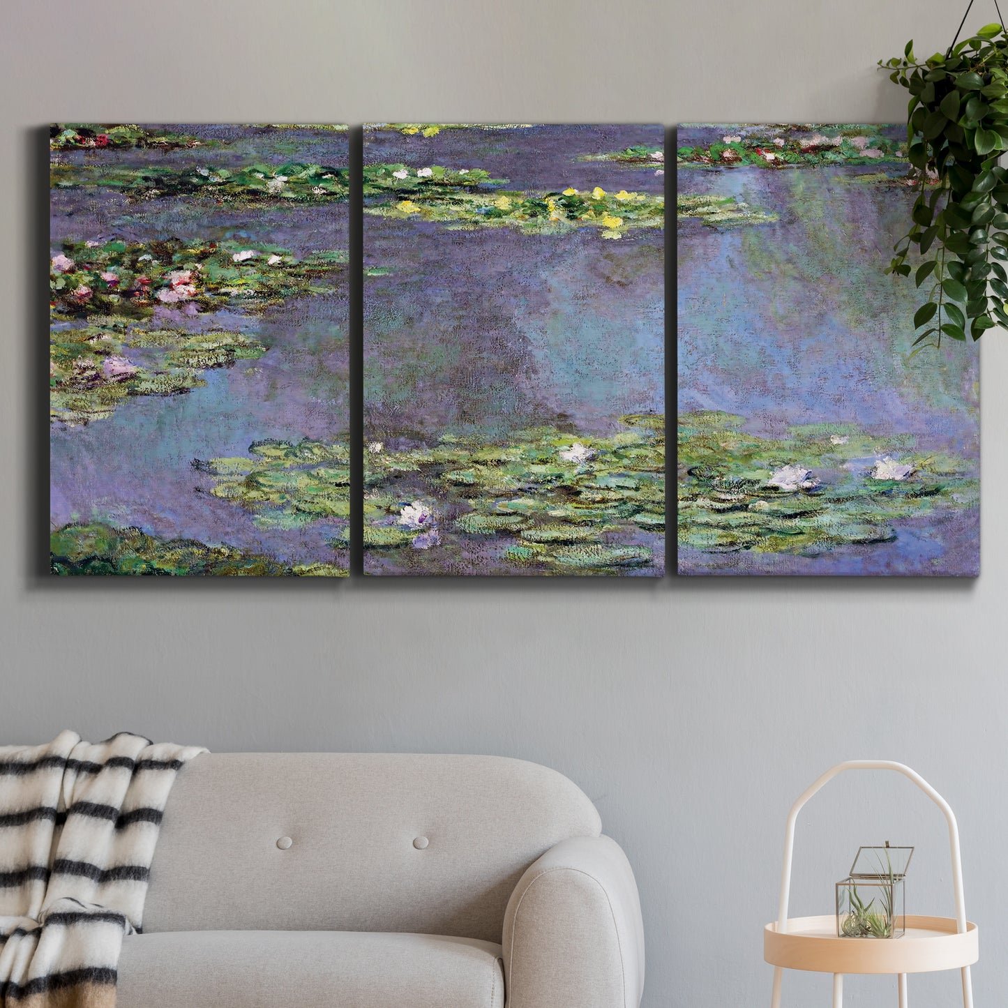 Three-panel canvas wall art featuring purple haze water lily pond, displayed in a modern living room above a sofa.