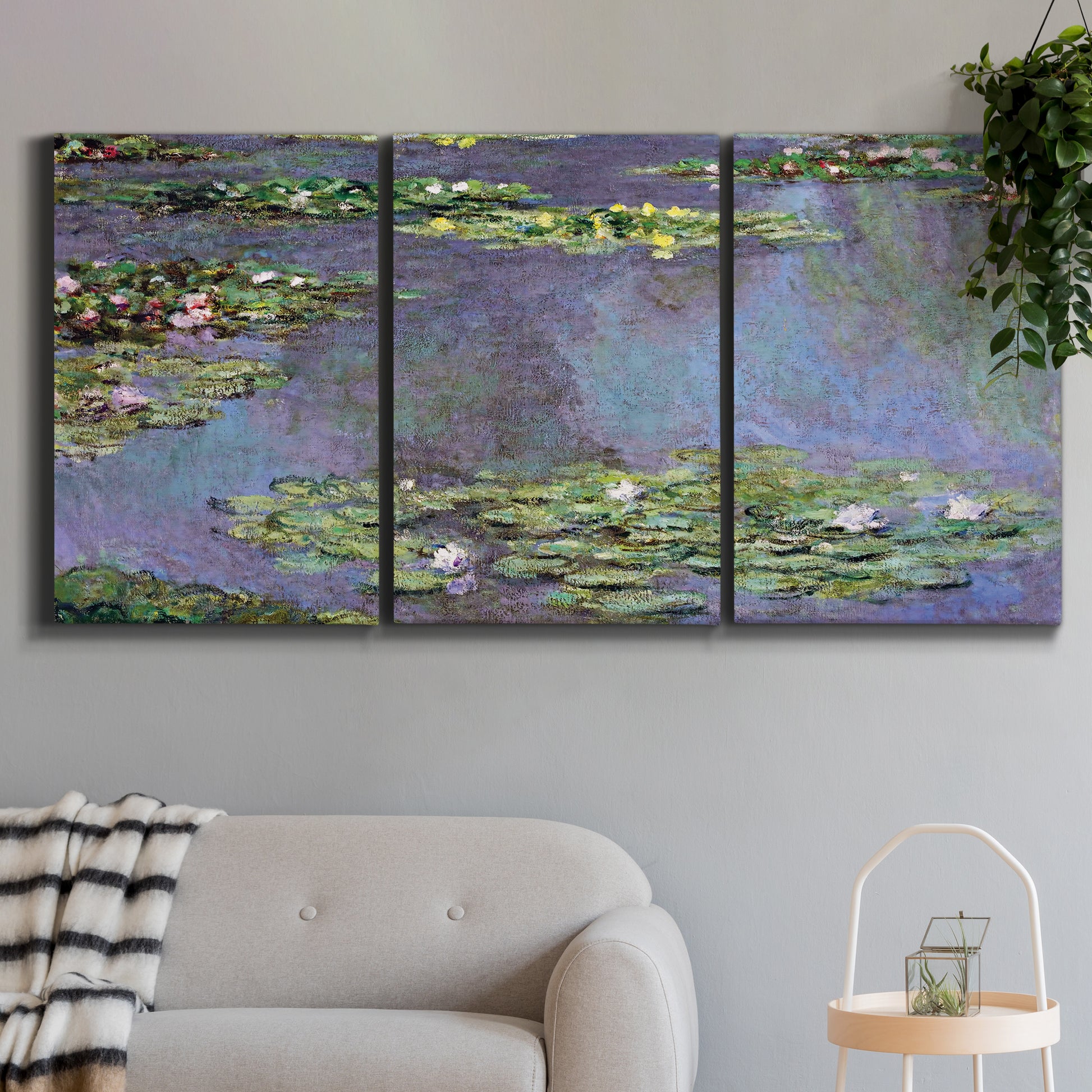Three-panel canvas wall art featuring purple haze water lily pond, displayed in a modern living room above a sofa.