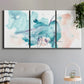 Three-panel canvas wall art featuring soft abstract watercolor forms, displayed in a modern living room above a sofa.