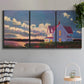Three-panel canvas wall art featuring farmhouse scene before approaching storm, displayed in a modern living room above a sofa.