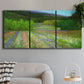 Three-panel canvas wall art featuring fresh spring meadow landscape, displayed in a modern living room above a sofa.