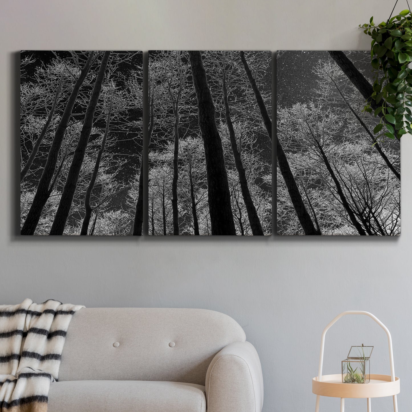 Three-panel canvas wall art featuring riverside houses along canal, displayed in a modern living room above a sofa.
