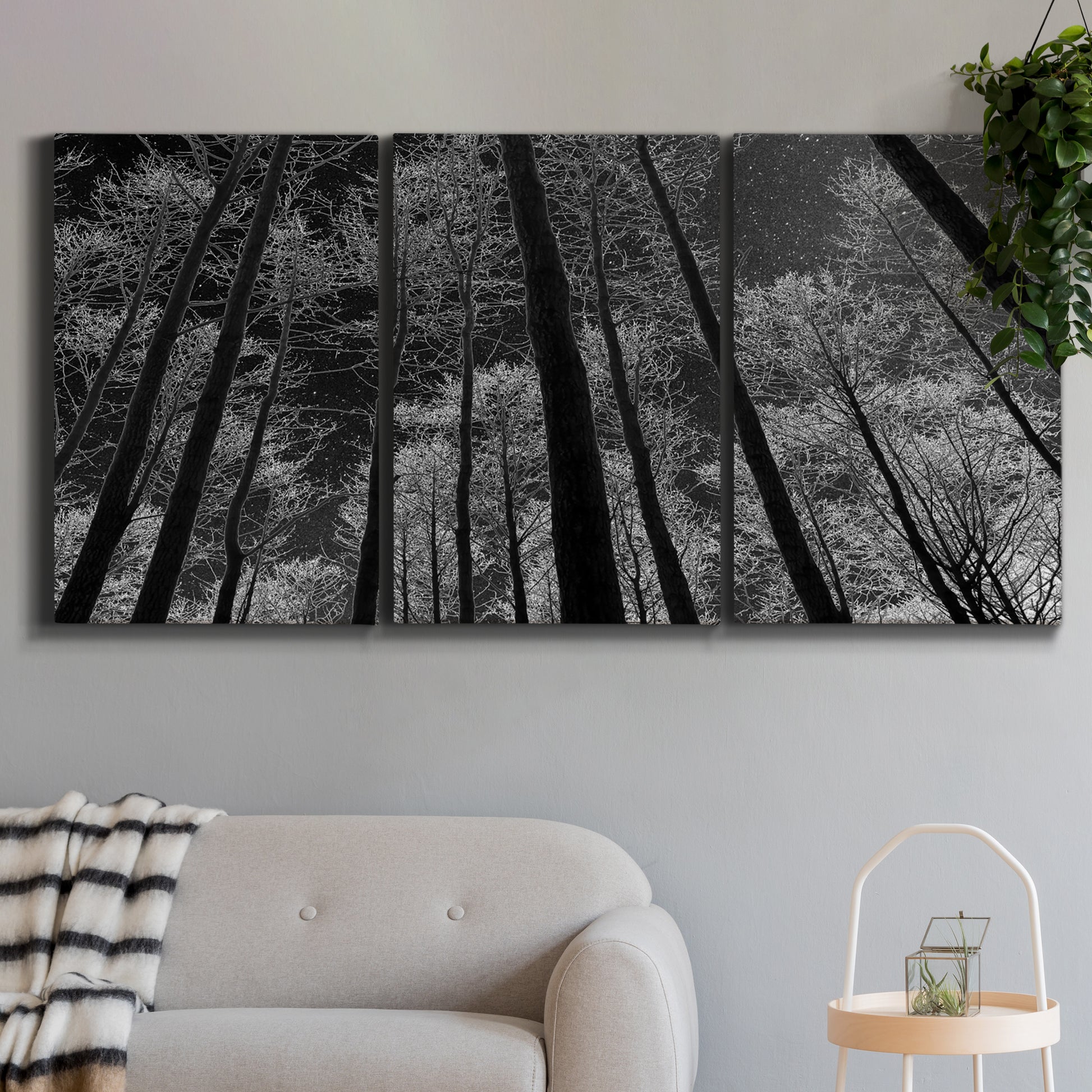 Three-panel canvas wall art featuring riverside houses along canal, displayed in a modern living room above a sofa.