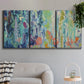 Three-panel canvas wall art featuring abstract rainfall with butterfly forms, displayed in a modern living room above a sofa.