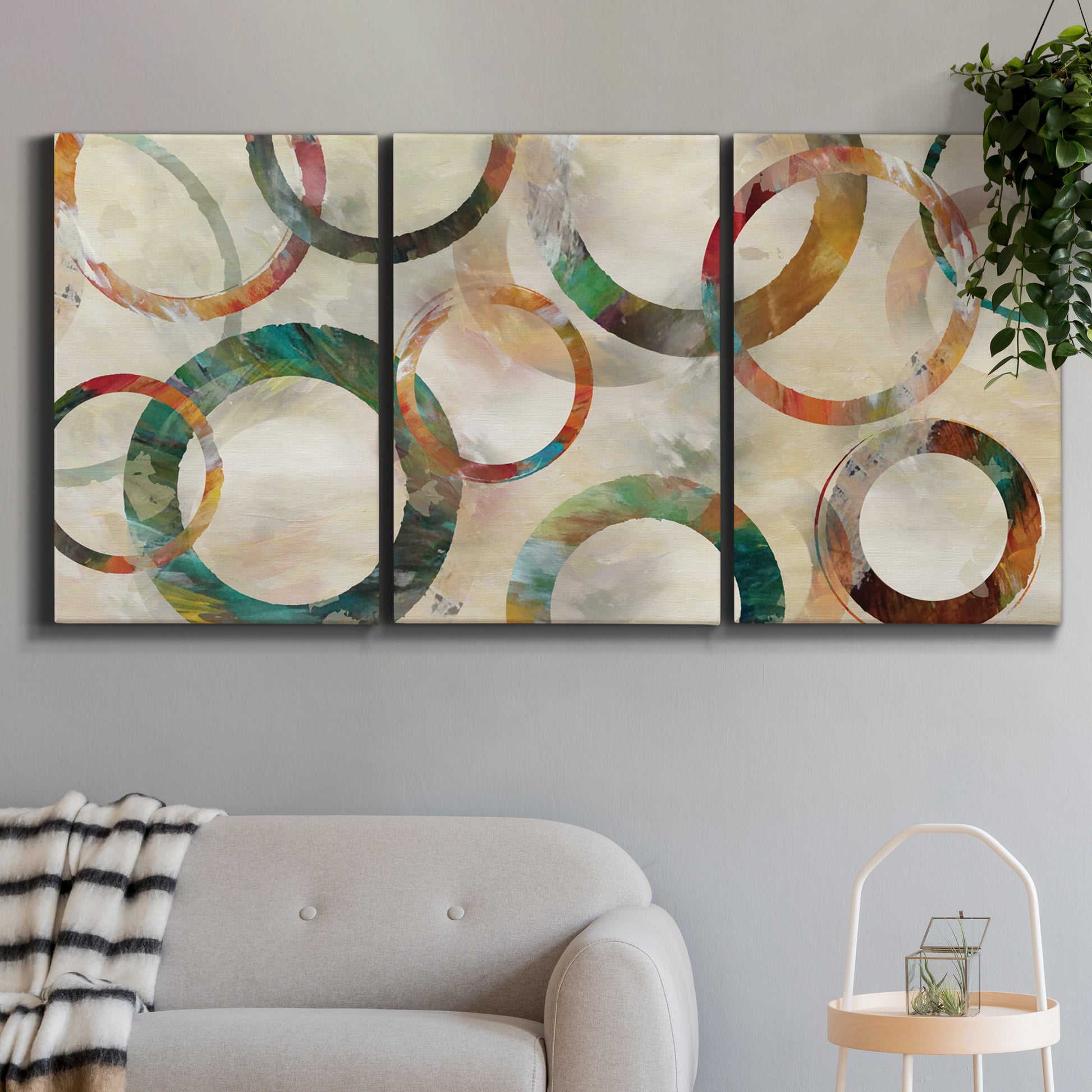 Three-panel canvas wall art featuring geometric circular abstract design, displayed in a modern living room above a sofa.
