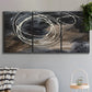 Three-panel canvas wall art featuring dark swirling abstract motion, displayed in a modern living room above a sofa.