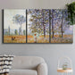 Three-panel canvas wall art featuring three poplar trees beside water, displayed in a modern living room above a sofa.