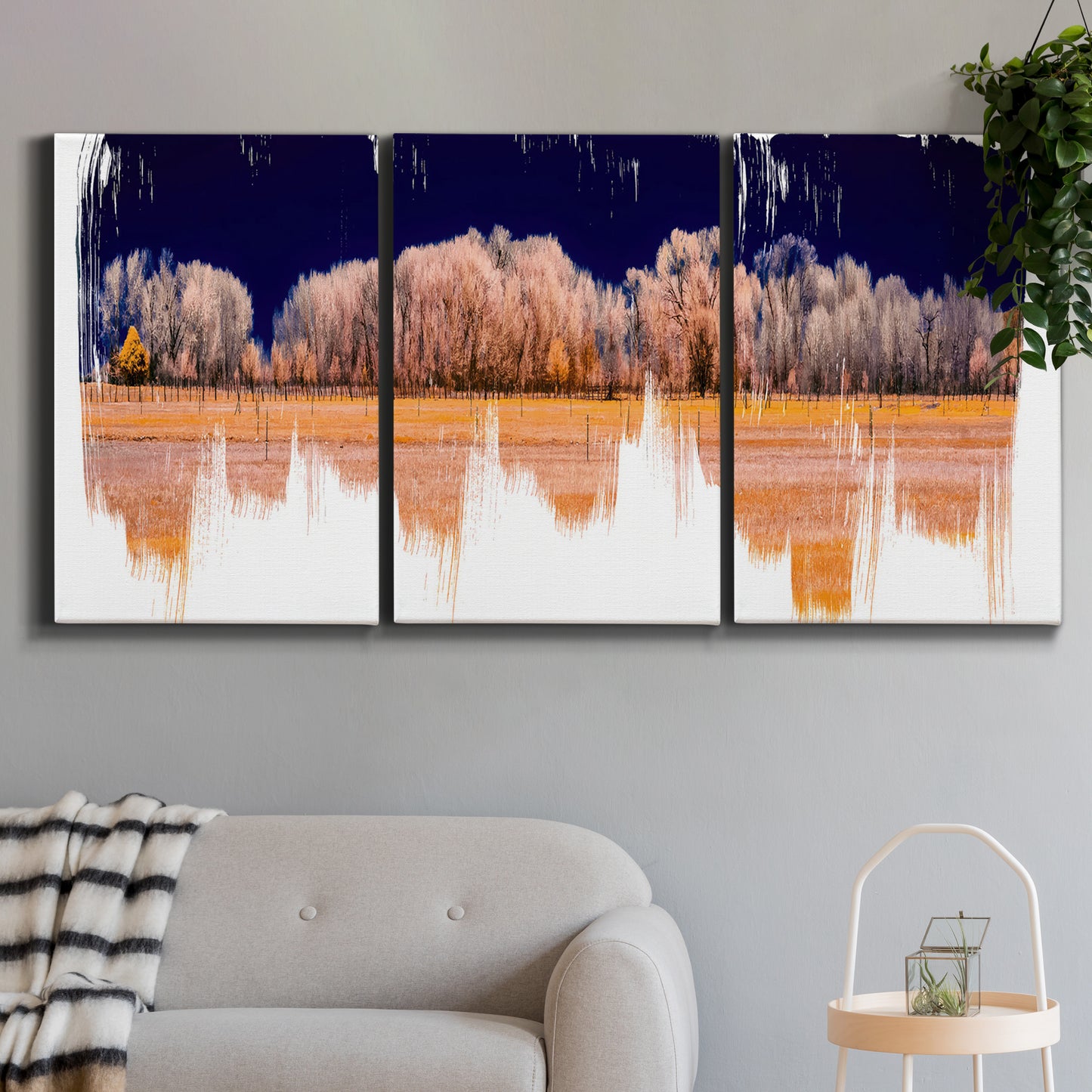 Three-panel canvas wall art featuring panoramic treeline landscape photograph, displayed in a modern living room above a sofa.