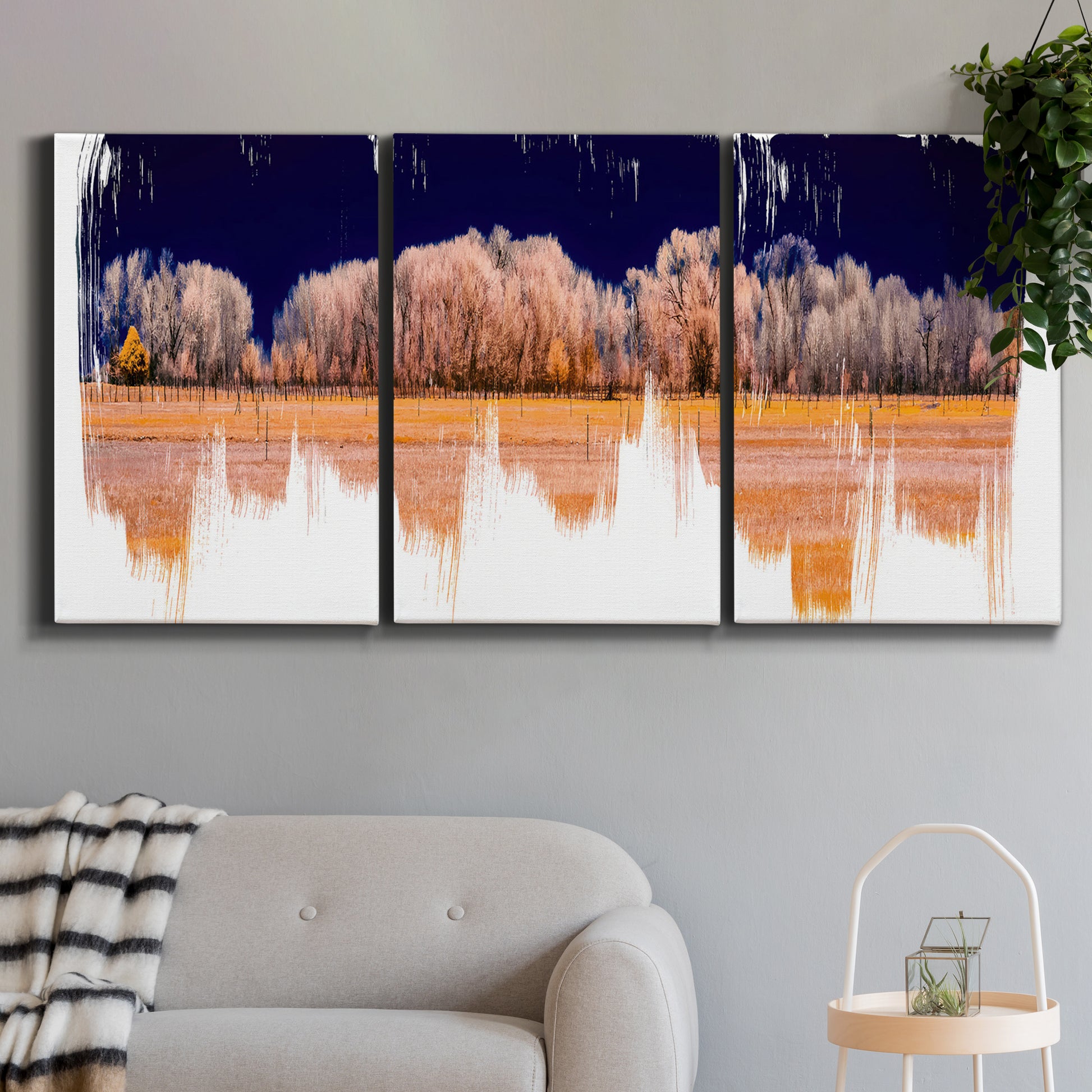 Three-panel canvas wall art featuring panoramic treeline landscape photograph, displayed in a modern living room above a sofa.