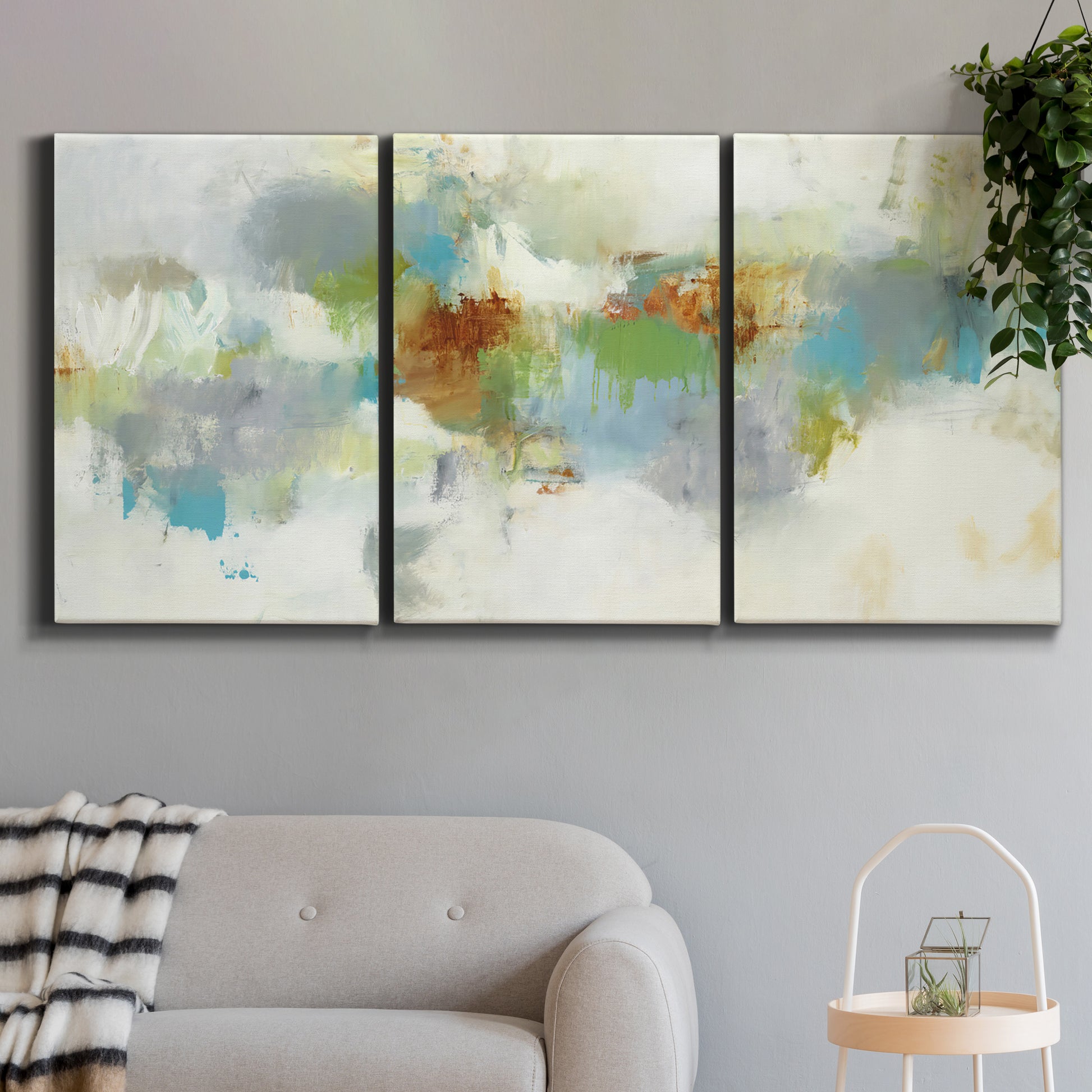 Three-panel canvas wall art featuring abstract suggestion of discovery, displayed in a modern living room above a sofa.