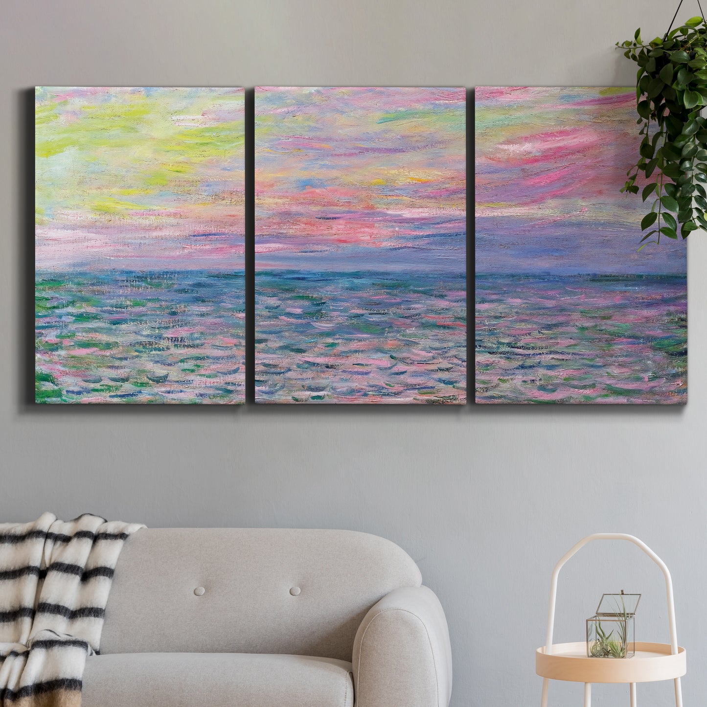 Three-panel canvas wall art featuring sunset reflections across calm sea, displayed in a modern living room above a sofa.