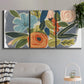 Three-panel canvas wall art featuring colorful botanical illustration, displayed in a modern living room above a sofa.