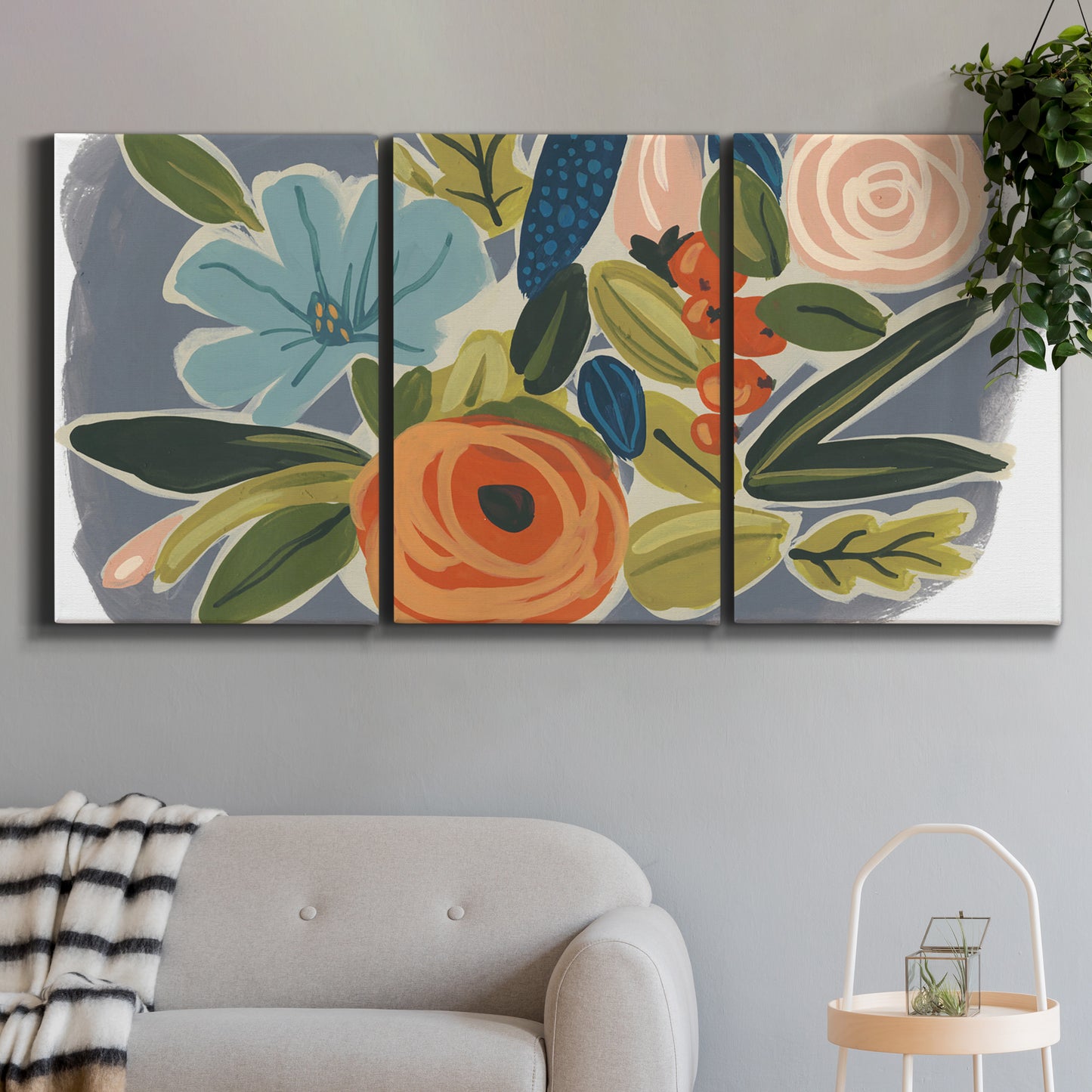 Three-panel canvas wall art featuring colorful botanical illustration, displayed in a modern living room above a sofa.