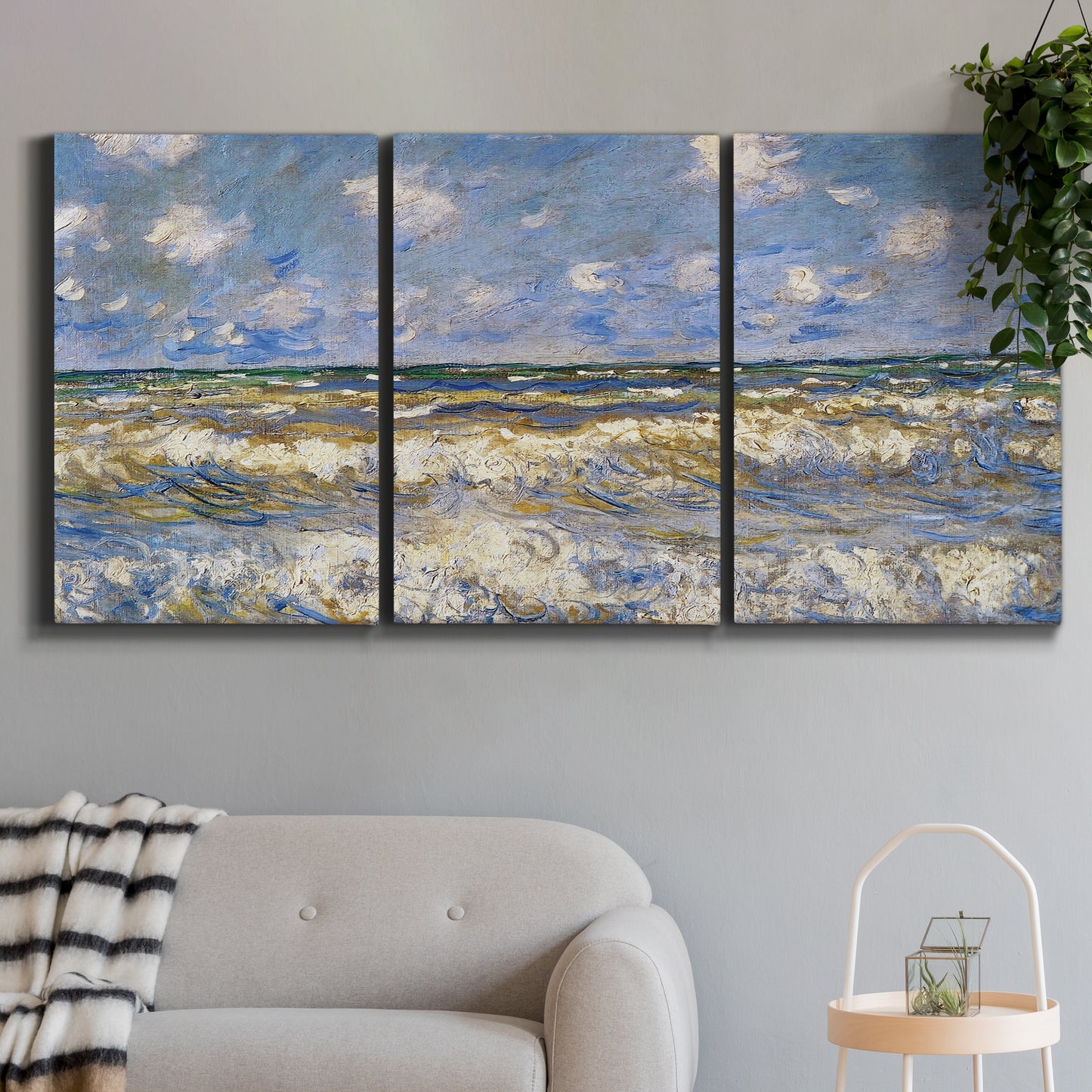 Three-panel canvas wall art featuring rough sea with crashing waves, displayed in a modern living room above a sofa.