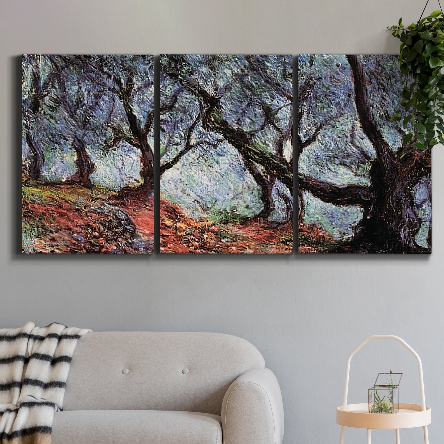 Three-panel canvas wall art featuring pine trees silhouetted at evening, displayed in a modern living room above a sofa.