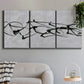Three-panel canvas wall art featuring minimal abstract frequency lines, displayed in a modern living room above a sofa.