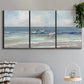 Three-panel canvas wall art featuring shore birds searching along beach, displayed in a modern living room above a sofa.