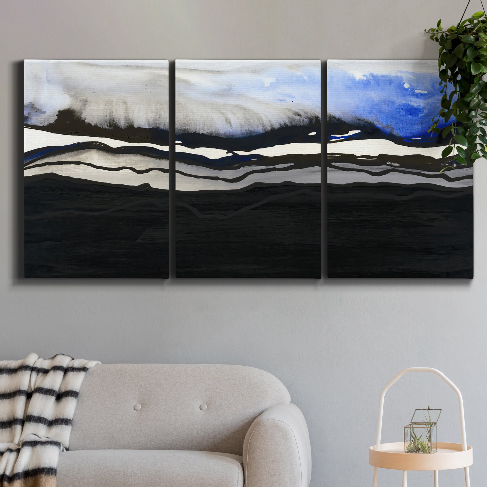 Three-panel canvas wall art featuring abstract passage of time composition, displayed in a modern living room above a sofa.