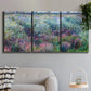 Three-panel canvas wall art featuring flowered riverbank with trees, displayed in a modern living room above a sofa.