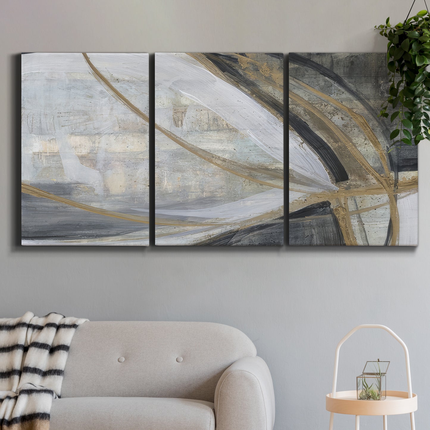 Three-panel canvas wall art featuring spiraling abstract vortex motion, displayed in a modern living room above a sofa.
