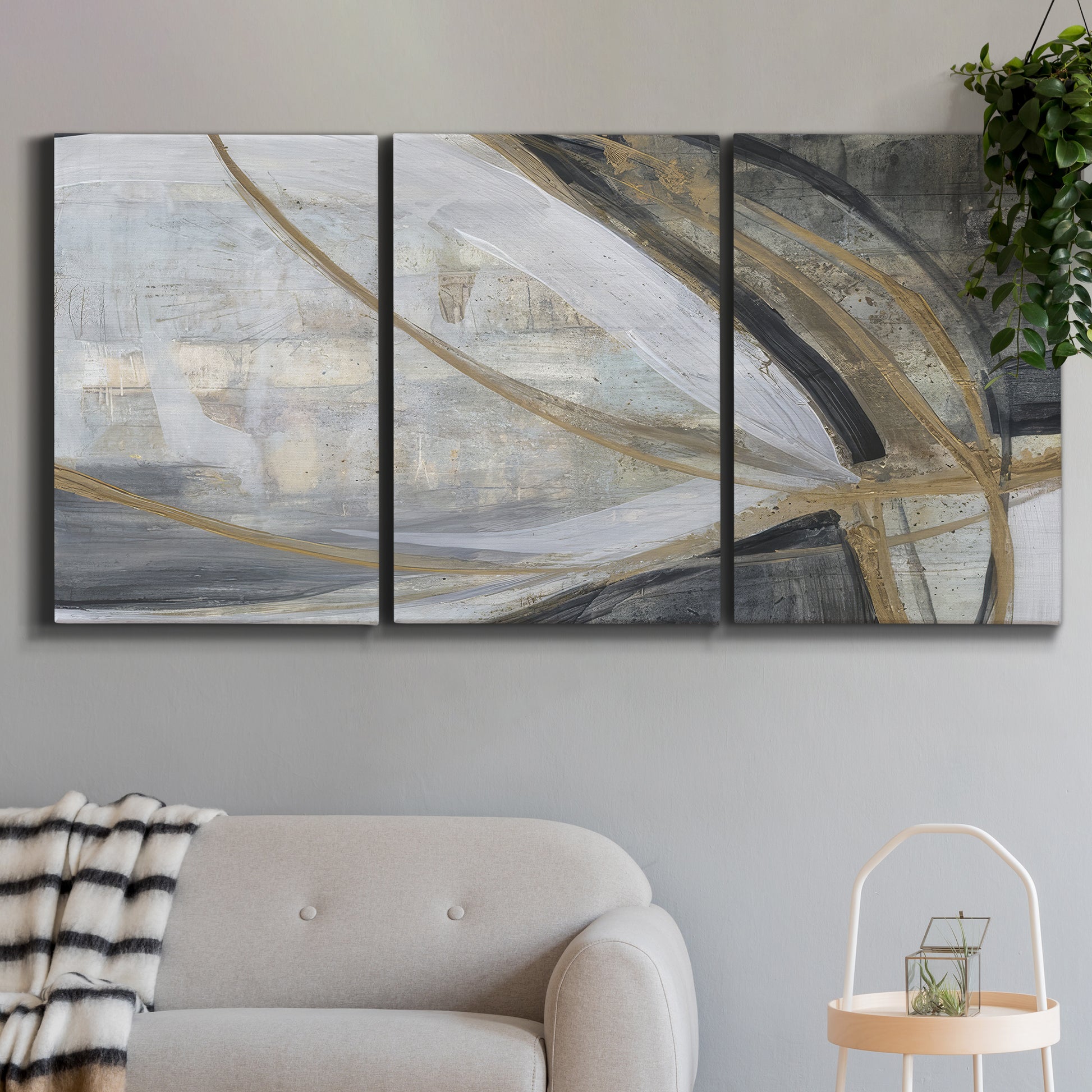Three-panel canvas wall art featuring spiraling abstract vortex motion, displayed in a modern living room above a sofa.