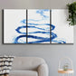 Three-panel canvas wall art featuring indigo abstract vapor watercolor, displayed in a modern living room above a sofa.