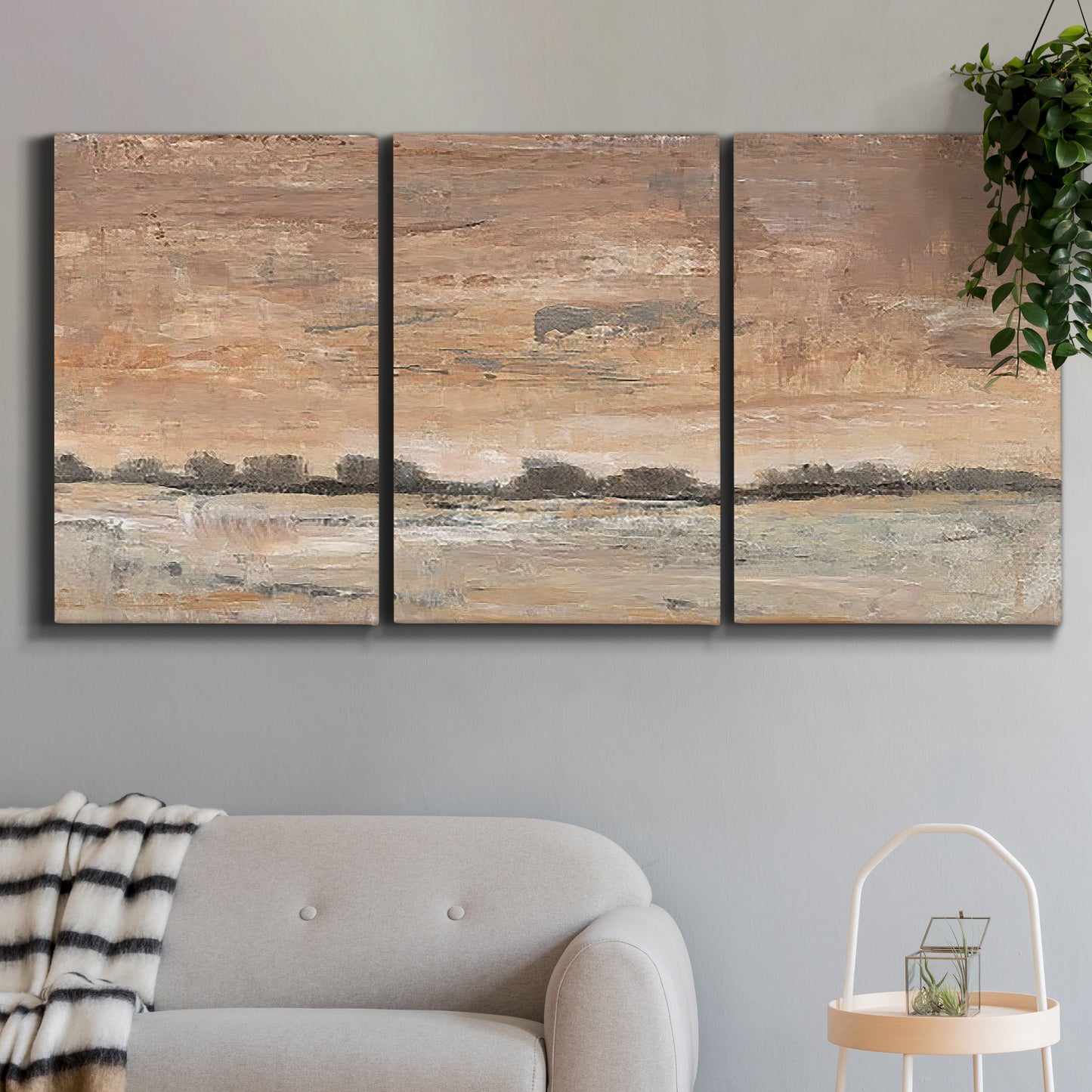 Three-panel canvas wall art featuring soft early evening landscape light, displayed in a modern living room above a sofa.