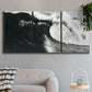 Three-panel canvas wall art featuring black and white crashing ocean waves, displayed in a modern living room above a sofa.