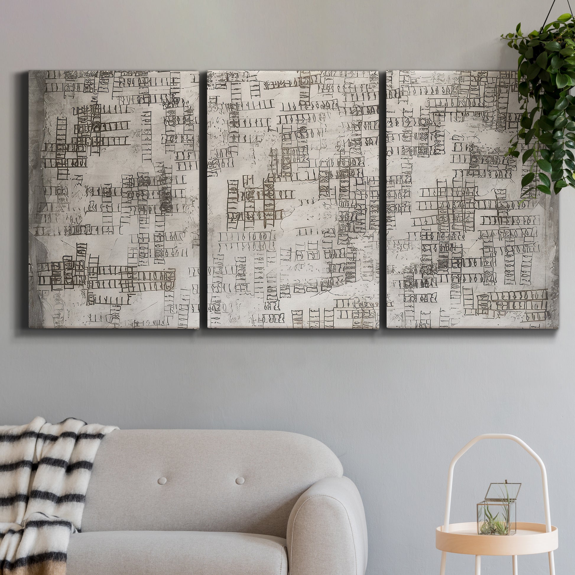 Three-panel canvas wall art featuring grid based geometric abstraction, displayed in a modern living room above a sofa.