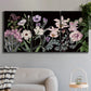 Three-panel canvas wall art featuring early spring blossoms in soft tones, displayed in a modern living room above a sofa.