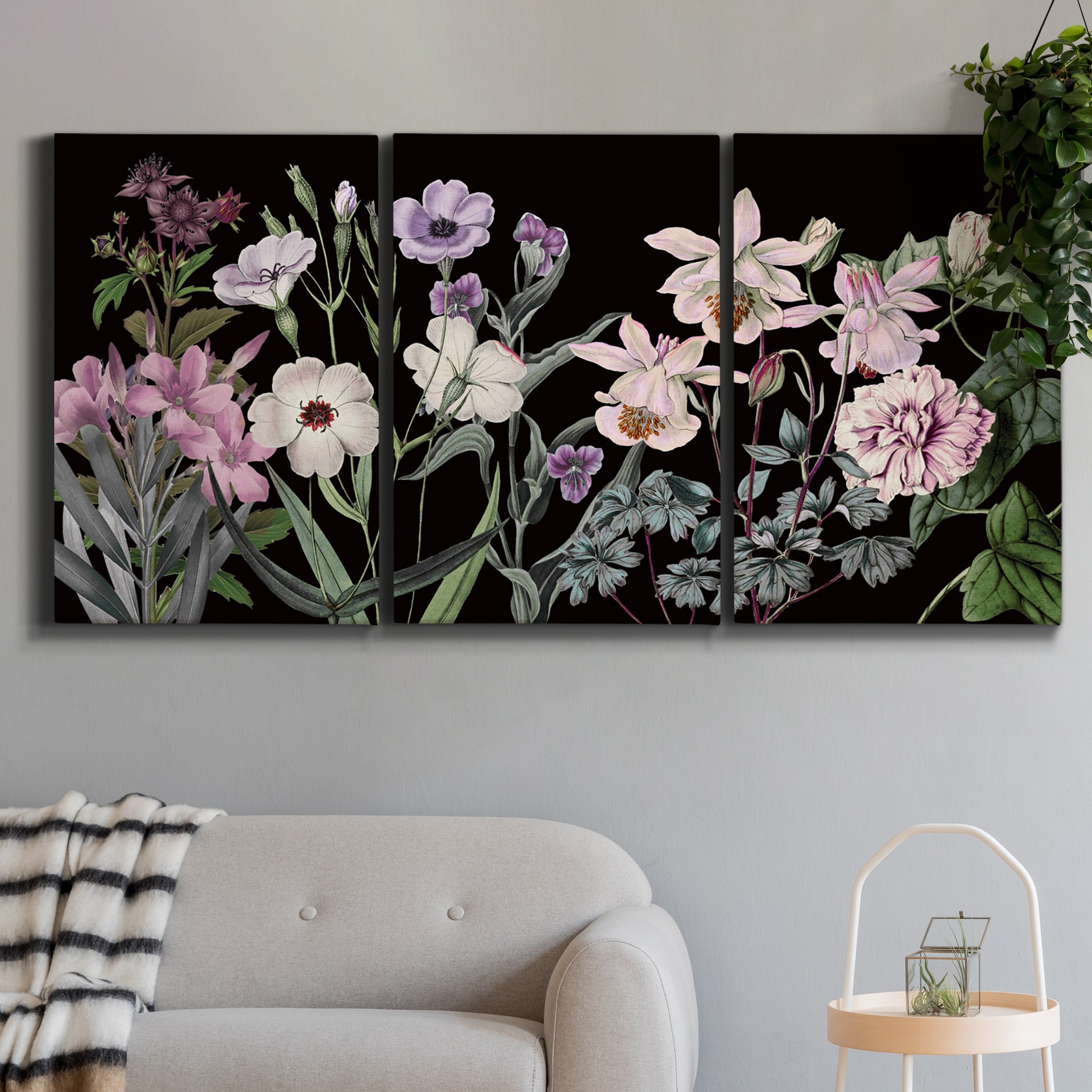 Three-panel canvas wall art featuring early spring blossoms in soft tones, displayed in a modern living room above a sofa.