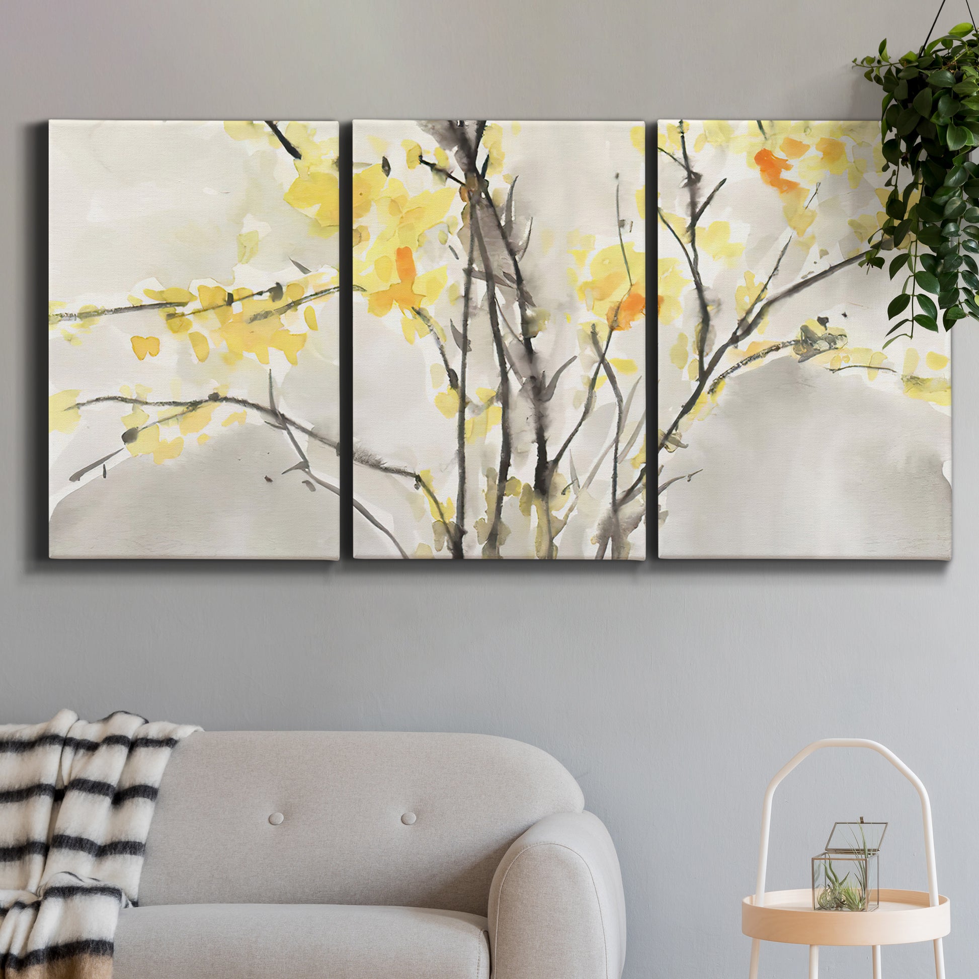 Three-panel canvas wall art featuring soft floral abstract harmony, displayed in a modern living room above a sofa.