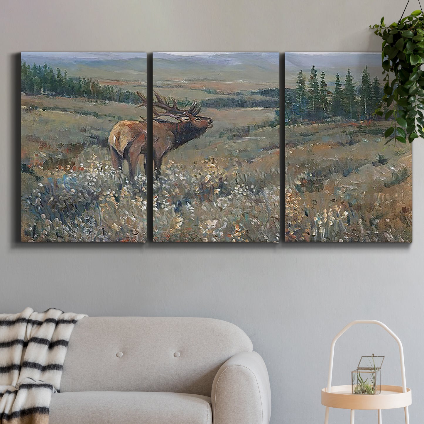 Three-panel canvas wall art featuring western wildlife grazing in open field, displayed in a modern living room above a sofa.