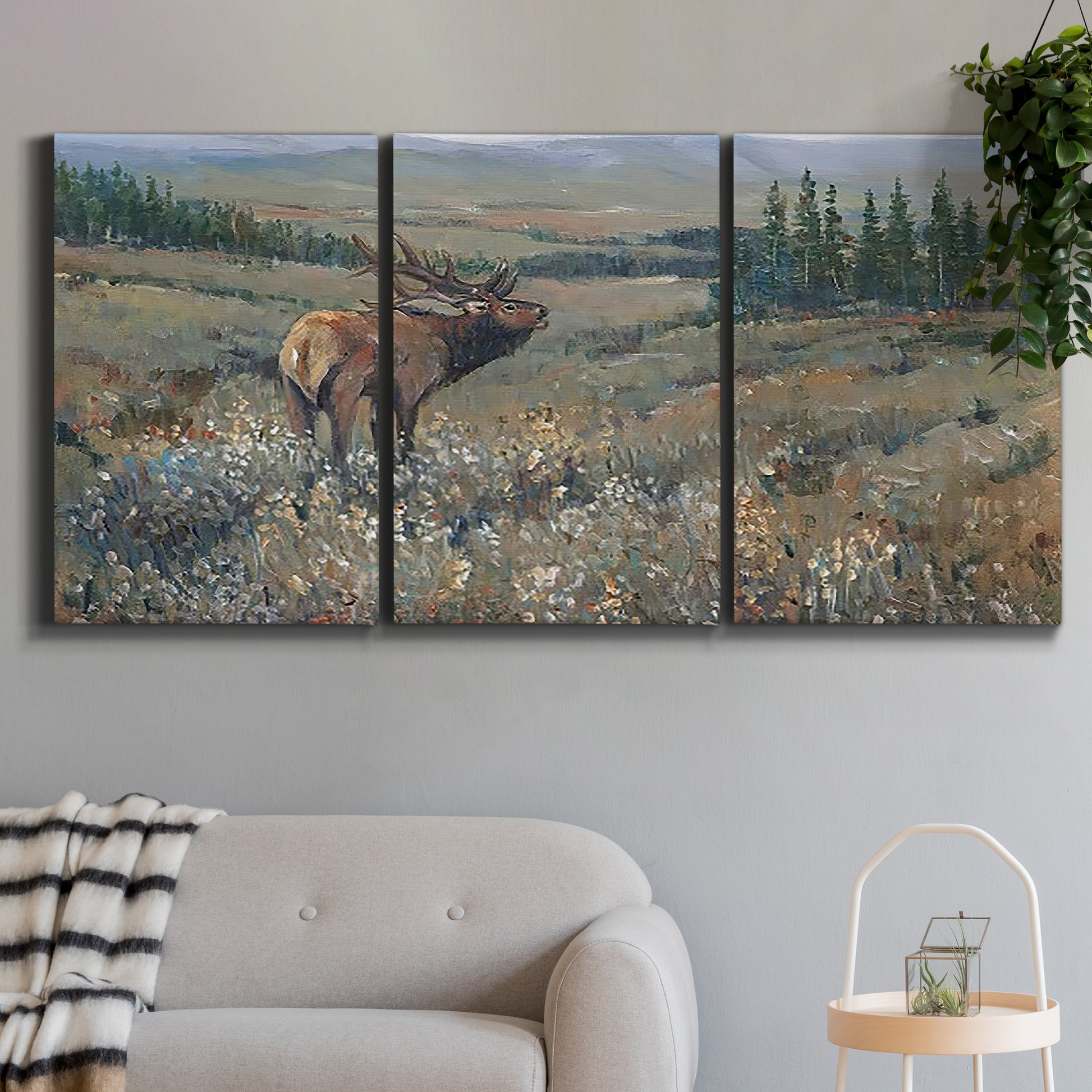 Three-panel canvas wall art featuring western wildlife grazing in open field, displayed in a modern living room above a sofa.