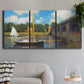Three-panel canvas wall art featuring bridge crossing river landscape, displayed in a modern living room above a sofa.