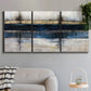 Three-panel canvas wall art featuring abstract blue urban composition, displayed in a modern living room above a sofa.