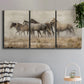 Three-panel canvas wall art featuring wild horses roaming open terrain, displayed in a modern living room above a sofa.