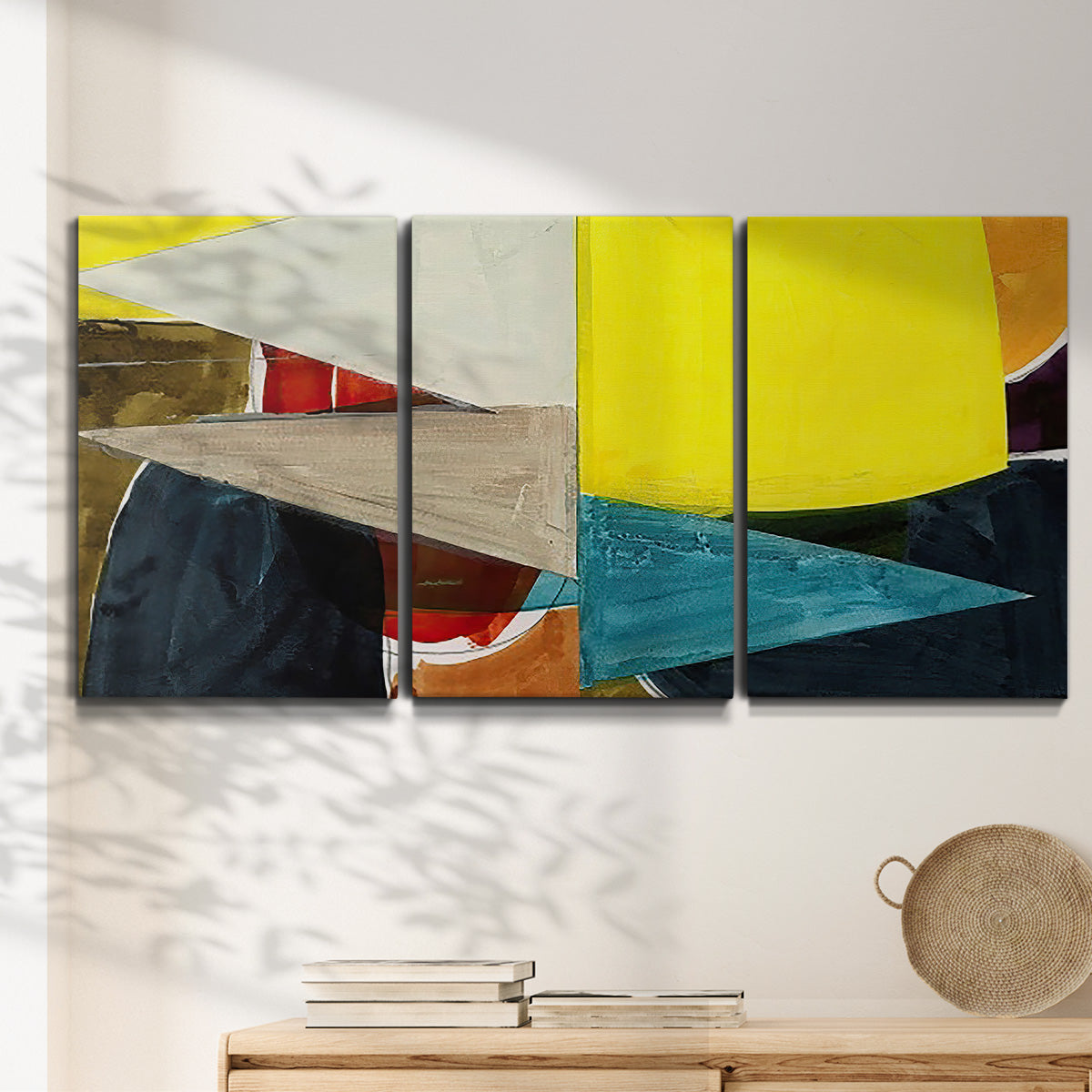 Three-panel canvas wall art featuring geometric mid century abstract blocks, displayed in a minimalist living room above a console table.