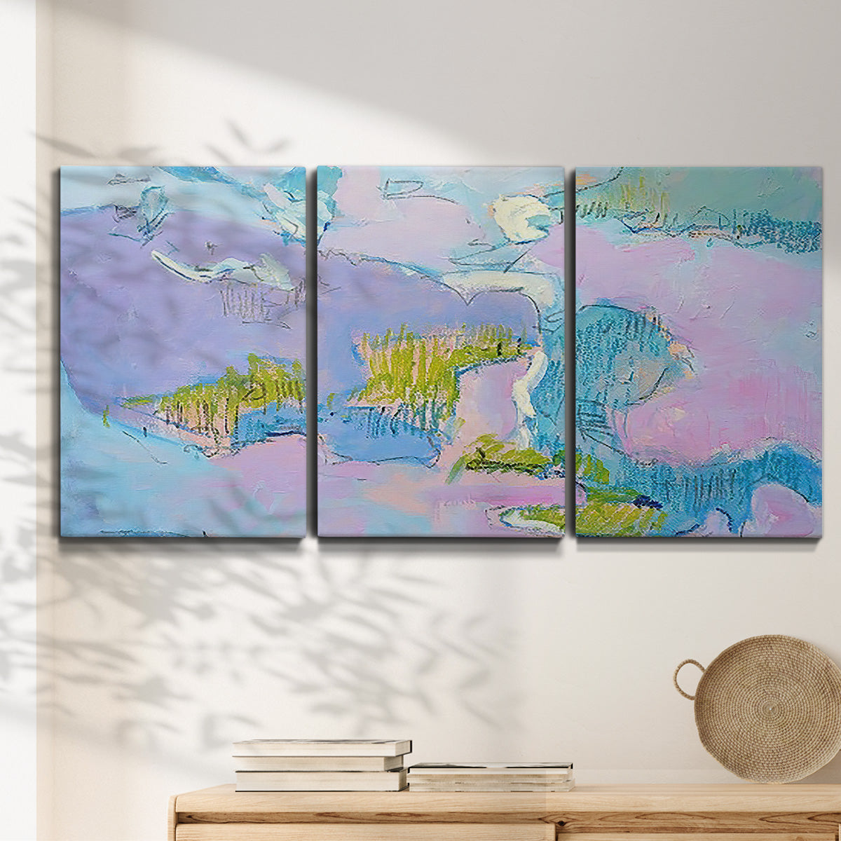 Three-panel canvas wall art featuring abstract view through window forms, displayed in a minimalist living room above a console table.