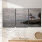 Three-panel canvas wall art featuring lighthouse watching over coastline, displayed in a minimalist living room above a console table.